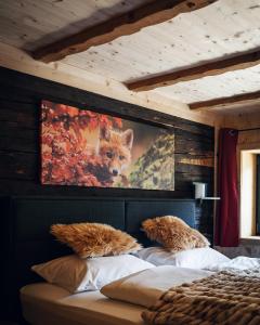 a bedroom with a painting of a fox on the wall at Alpen Lodge Berwang in Berwang