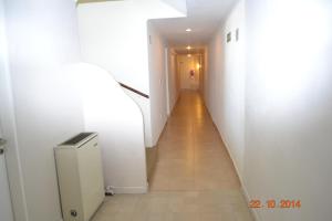 
a hallway with a white wall and a white toilet at Horizonte Hotel in Mar del Plata
