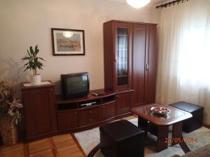 a living room with a tv and a cabinet at Guest house Marcel in Lovran