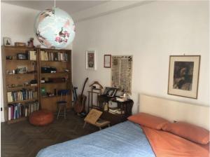 a bedroom with a bed and a book shelf at camera in via Tolstoi in Milan