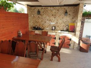 a dining room with a wooden table and chairs at Casa Jasmin in Năvodari