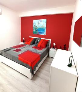 a red bedroom with a bed with red walls at La casa di Giada in Calatabiano