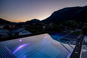 a swimming pool on the roof of a house at Der Postwirt in Söll