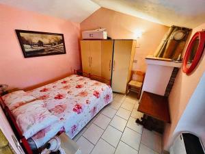 a small bedroom with a bed and a cabinet at La Villetta in Cansano