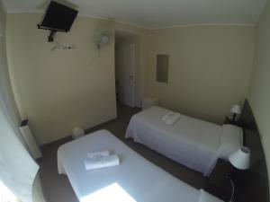 מיטה או מיטות בחדר ב-Horizonte Hotel