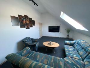 a living room with a couch and a table at Ferienhaus Heimberg - Fischach in Fischach