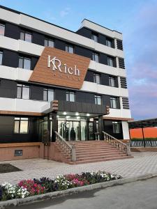 a building with a right sign on it at KRich Hotel Aktobe in Aktobe