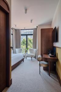 a hotel room with a bed and a desk at GentleTom in Istanbul