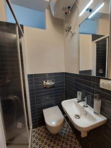 a bathroom with a sink and a toilet and a shower at La casa di Zefiro in Corniglia