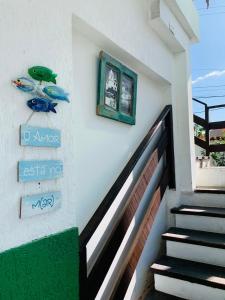 a stairway with a green picture on a wall at Pousada Arraial Caribe in Arraial do Cabo