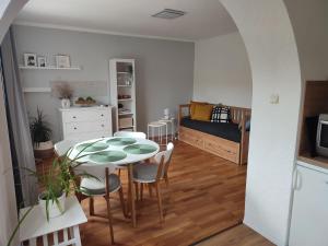 a room with a table and chairs and a bedroom at Apartmán Lenka in Boršice