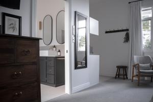 a bathroom with a sink and a mirror at Walton House in Huonville