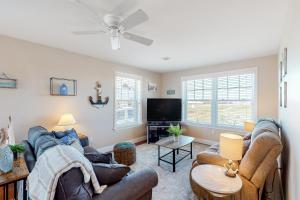 a living room with two couches and a flat screen tv at Sunset Pointe in Hampton