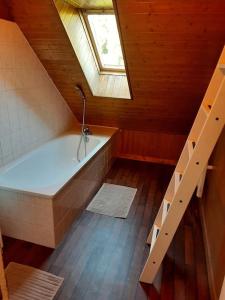 a attic bathroom with a bath tub and a skylight at Gite 3 chambres chambres, calme et bien placé in La Forest-Landerneau