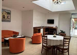 a living room with a table and a couch at Nico Hotel in Antigua Guatemala