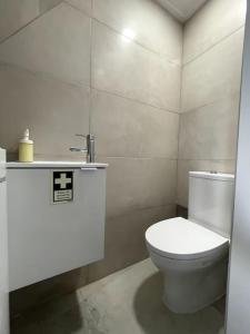 a bathroom with a white toilet and a sink at CASA ALCOCHETANA in Alcochete