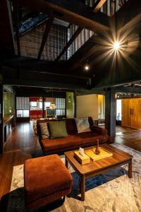 a living room with a couch and a coffee table at LiveGRACE House Lake Saiko 西湖古民家 in Yamanashi