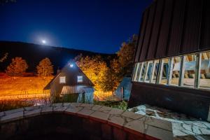 a house with a light on the side of it at night at Stairway - Vučje in Nikšić +45 photos