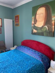a bedroom with a bed with a painting on the wall at Maria Vittoria House in Turin