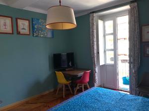 a bedroom with a table and chairs and a window at Maria Vittoria House in Turin