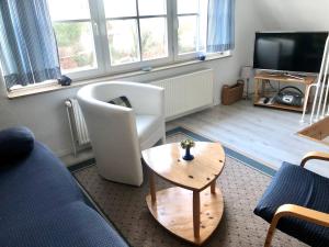 a living room with a couch and a table at Strandbummelhaus in Warnemünde