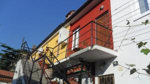 um edifício colorido com uma janela e uma varanda em Casa dei Gelsomini em Trieste