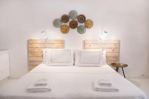 a bedroom with a large white bed with two towels at Yasos By The Sea in Çeşme
