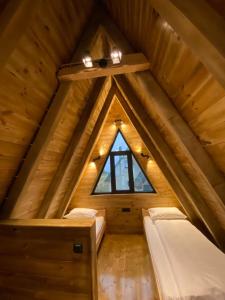 a attic bedroom with two beds and a window at DANDELION HOUSE in Žabljak