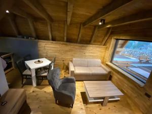 a living room with a couch and a table at DANDELION HOUSE in Žabljak