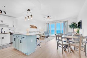 a kitchen and living room with a table and chairs at Laketown Wharf 1714 in Panama City Beach