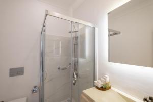 a shower with a glass door in a bathroom at Yasos By The Sea in Çeşme