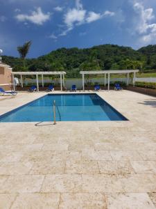 a swimming pool with chairs at Ocean Pointe, Lucea, Hanova, Jamaica in Lucea