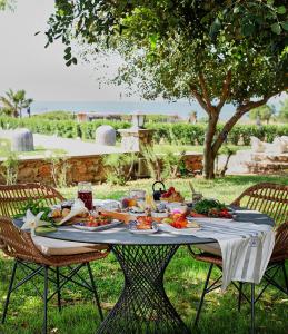 una mesa con comida en ella con dos sillas en Flow Datca Surf & Beach Hotel en Datca