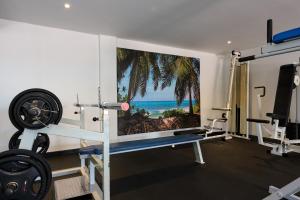 a gym with a poster of the beach at Bubali Luxury Apartments - Adults Only - Wheelchair Friendly in Palm-Eagle Beach