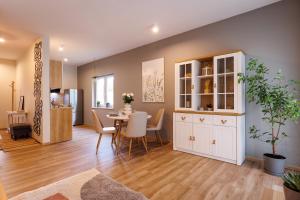 a dining room and living room with a table and chairs at Stylowe apartamenty in Charzykowy