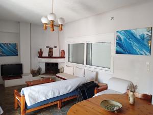 a living room with a bed and a table at Villa Karla in Pefkali