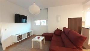 Televízia a/alebo spoločenská miestnosť v ubytovaní Apartamento Alegría
