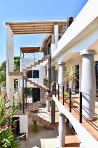 a white house with stairs and plants at Carri Surf Studio in Puerto Escondido