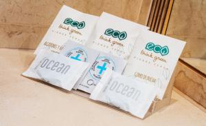 a group of four bags of toothpaste sitting on a counter at Don Paco in Llanes