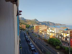 a view of a city with cars parked on a street at stanza vista mare in Giardini Naxos