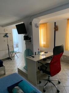 a room with a desk and a bedroom with a bed at studio in old town of Mytilene in Mytilini