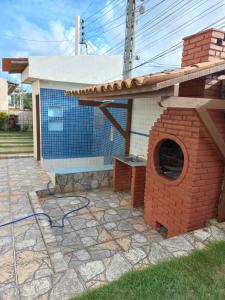 a brick oven in the yard of a house at Aconchegante Apt FRENTE AO MAR in Barra de São Miguel