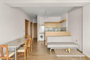 a kitchen and dining room with a table and chairs at Mathios apartments Falassarna in Falasarna