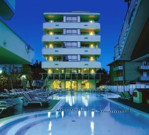 a hotel with a swimming pool in front of a building at Hotel Madison - Cattolica in Cattolica