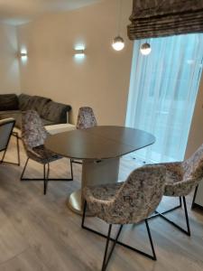 a dining room with a table and chairs at Apartamentai in Garliava