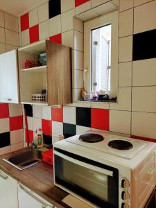 a kitchen with a stove and a sink in it at Vita apartments in Zagreb