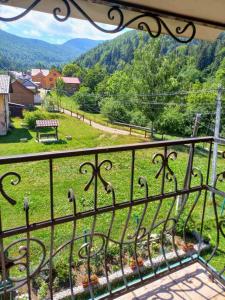 a balcony with a view of a field of grass at Cottage "Kliverent" in Yaremche