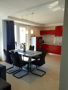 a kitchen and dining room with a table and chairs at Apartment Hajdi in Podstrana