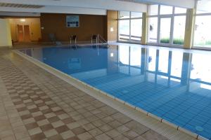 a large swimming pool with blue tiles in a building at Appartement Malejo am Hochkönig in Bachwinkl