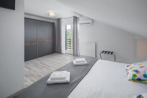 a bedroom with a large bed with two towels on it at Villa Bella, villa with heated Pool in Cerovlje +36 photos